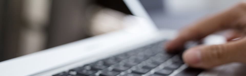 Man typing on laptop computer