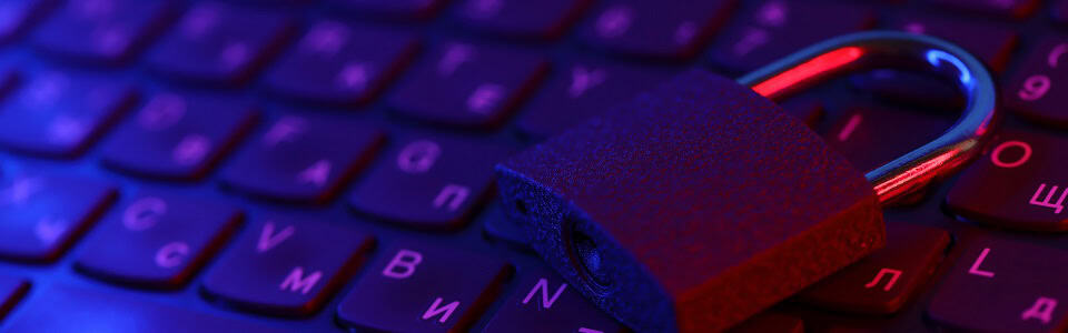 Computer security concept with a closed padlock on the keyboard. Padlock on top of a laptop keyboard. Selective focus