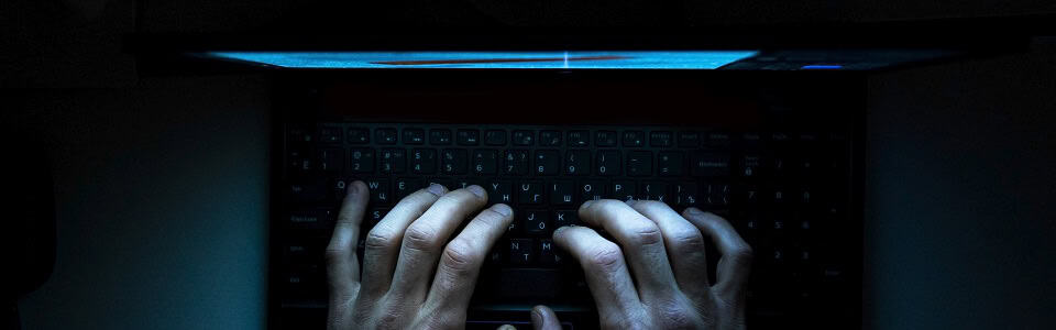 Top view of the hands of a programmer on his laptop